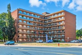 Burlington apartment for rent - A large red brick apartment building with balconies and multiple windows.