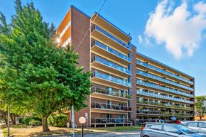 Burlington apartment for rent - A large apartment building with a parking lot in front.