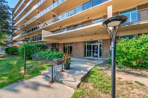 Burlington apartment for rent - A building with a balcony and a tree in front of it.