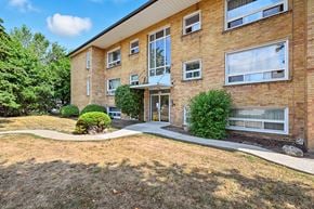 Oakville apartment for rent - A building with a brown brick exterior and a white door.