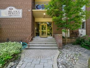 Barrie apartment for rent - The front of Blake Street Apartments with a green tree in front.