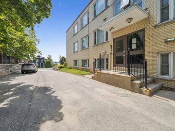 Barrie apartment for rent - A street view of a residential area with a building on the right.