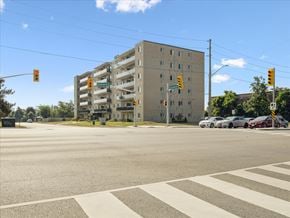 Barrie apartment for rent - A large building with a parking garage in front of it.