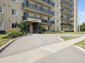 Barrie apartment for rent - The entrance to the Mayfair apartment complex is surrounded by landscaping.