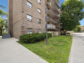 Orillia apartment for rent - A tall brick building with a balcony on the second floor.