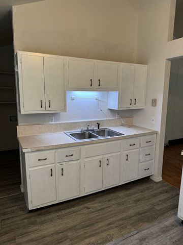 Lima house for rent - A kitchen with white cabinets and a sink.