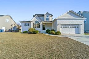 Jacksonville house for rent - A white house with a grey roof and a garage door.