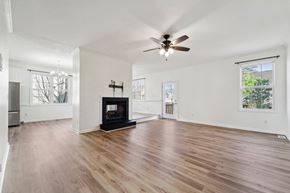 Jacksonville house for rent - A spacious living room with a fireplace and hardwood floors.