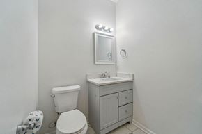 Jacksonville house for rent - A white toilet sits next to a sink in a small bathroom.