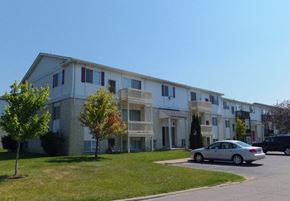 Monroe apartment for rent - A silver car is parked in front of a white apartment building.