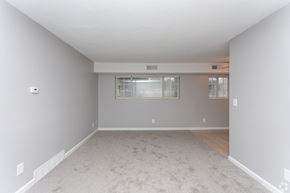 Monroe apartment for rent - A spacious empty room with a window and a door.