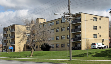 Scarborough apartment for rent - Apartment building with a white van parked in front.
