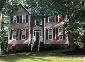 Kernersville house for rent - A two-story house with a red and white striped facade.