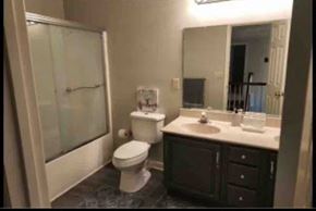 Kernersville house for rent - A bathroom with a toilet, sink, and shower.