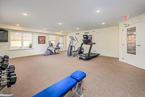 Statesville apartment for rent - A gym with a bench, weights, and exercise equipment.