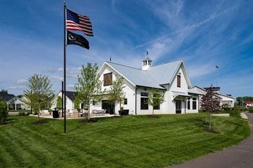 Lewis Center apartment for rent - A white building with a black and white flag flying in front of it.