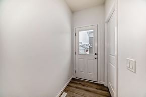 Edmonton apartment for rent - A white door with a glass window is in a room with white walls.