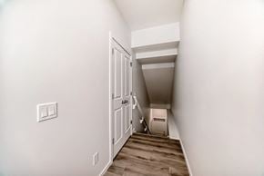 Edmonton apartment for rent - A hallway with a white door and a light switch on the wall.