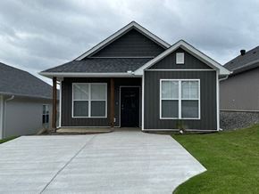 Little Rock house for rent - A grey house with a black roof and a white door.