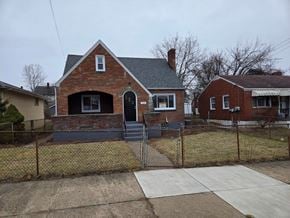 Clairton house for rent - A red brick house with a black door and a grey roof.