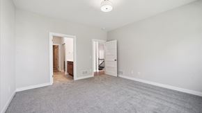 Blaine house for rent - A spacious room with a carpeted floor and two doors.