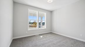 Blaine house for rent - A room with a large window showing a view of trees and a blue sky.