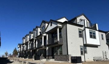 Bend apartment for rent - A row of modern townhouses with balconies and black railings.