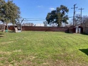 Round Rock house for rent - A large grassy field with a fence and trees in the background.