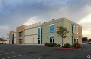 Long Beach apartment for rent - A large building with a parking lot in front of it.