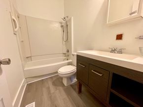 Louisville apartment for rent - A white toilet is in a bathroom next to a sink.
