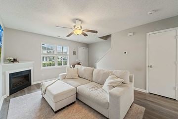 Jacksonville house for rent - A living room with a white couch and a fireplace.