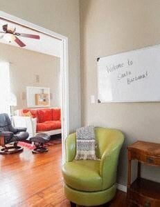 Santa Barbara house for rent - A room with a green chair and a white sign on the wall.
