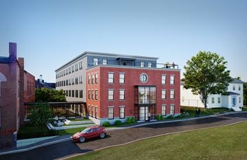 Bath apartment for rent - A red car is parked on the street in front of a red brick building.