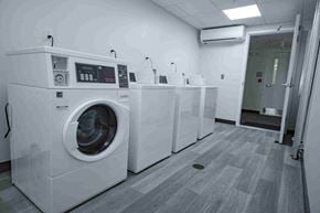 Bath apartment for rent - A row of washing machines in a laundromat.