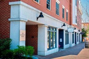 Exeter apartment for rent - A building with a sign that says "The Squash Block".