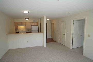 Exeter apartment for rent - A kitchen area with a refrigerator, oven, and microwave.