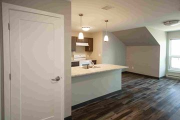 Old Orchard Beach apartment for rent - A kitchen with a white door and a counter.