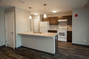 Old Orchard Beach apartment for rent - A kitchen with a white island and wooden floors.