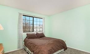 Fort Collins apartment for rent - A bedroom with a bed and a window.