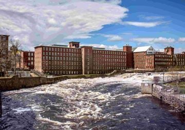 Biddeford apartment for rent - A river flows through a city with buildings on both sides.