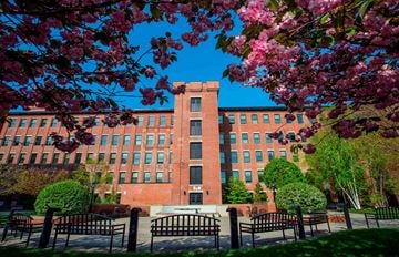 Lewiston apartment for rent - A red brick building with a black gate in front.