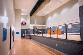 Bath apartment for rent - A long hallway with a basketball court at the end.