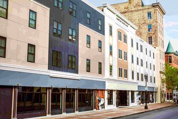 Lewiston apartment for rent - A street view of a row of buildings with a clear sky in the background.