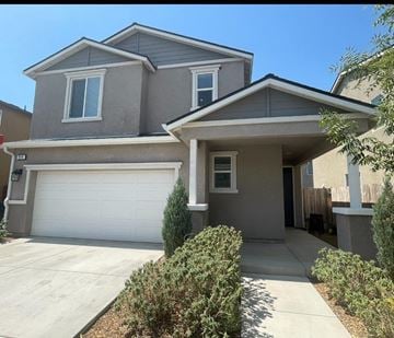 Clovis house for rent - A two-story house with a garage and a driveway.