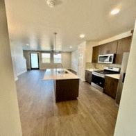 Bend apartment for rent - A kitchen with a microwave and oven built into the cabinetry.