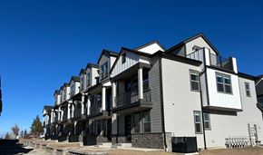Bend apartment for rent - A row of modern townhouses with balconies and black railings.