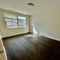 Bend apartment for rent - A room with a window and wooden floors.