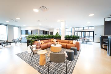 Columbus apartment for rent - A modern kitchen and living room with a beige sofa and wooden floors.