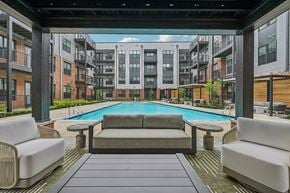 Columbus apartment for rent - A patio with a pool surrounded by buildings.