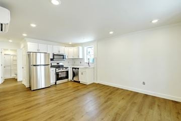 Providence apartment for rent - A kitchen with white cabinets and a wooden floor.